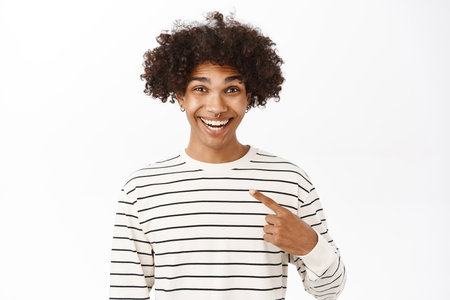 Close up portrait of smiling handsome man pointing finger at himself, self-promoting, talking about him, standing over white backgroundの写真素材