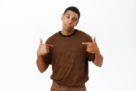 African american man pointing at himself, standing in casual clothesの写真素材