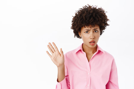 Image of displeased woman rejecting bad offer, wave hand away to decline smth, saying no, standing over white backgroundの写真素材