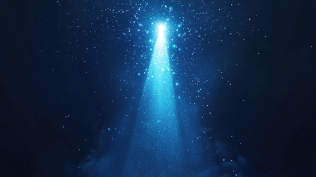 Abstract blue light beam illuminating sparkling particles