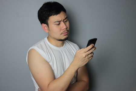 A man is looking on the mobile phone.の写真素材