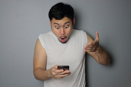 A man get good news from mobile phone.の写真素材
