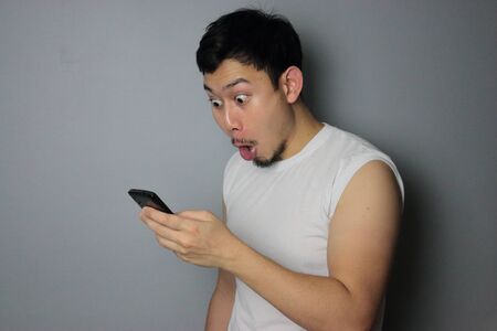 A man get good news from mobile phone.の写真素材