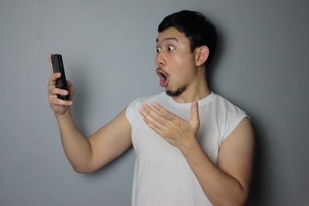 A man get good news from mobile phone.の写真素材