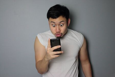 A man get good news from mobile phone.の写真素材