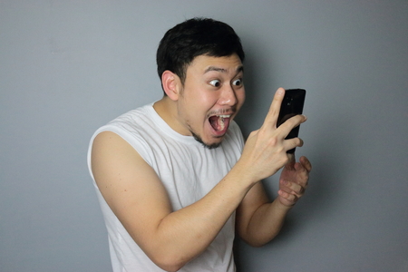 A man get good news from mobile phone.の写真素材