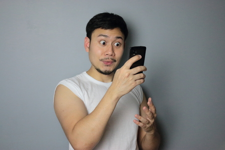 A man get good news from mobile phone.の写真素材