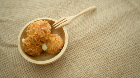 Cheese balls in a wooden bowl.