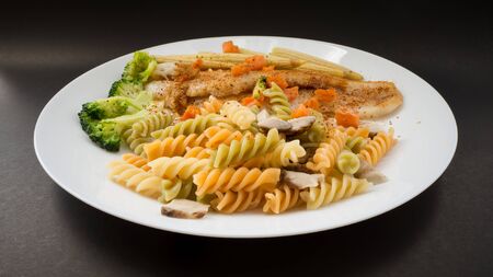 Colourful Pasta on white dish.の写真素材