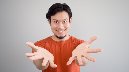 Asian man is presenting a product or idea.の写真素材