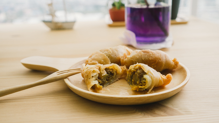 Curry Puffs on wooden dish. and Butterfly Pea tea.の写真素材