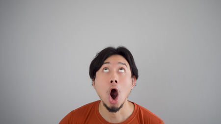 Surprised Asian man in red t-shirt.の写真素材