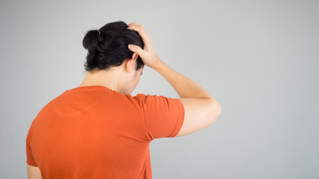 Sad Asian man in red tshirt.の写真素材