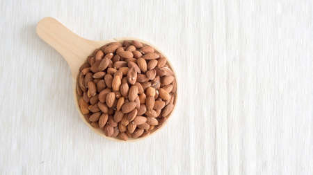 Pile of almonds on wooden plate.の写真素材