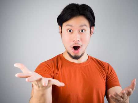 Surprised Asian man in red t-shirt.の写真素材