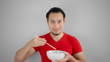 Asian man eat instant noodles.の写真素材