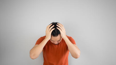 Sad Asian man in red tshirt.の写真素材