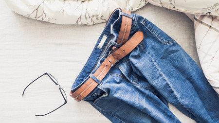 Man outfit laid on bed in the morning light.の写真素材
