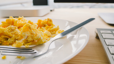 Scrambled eggs on white dish.の写真素材
