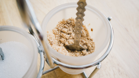 White and brown sugar in glasses.の写真素材