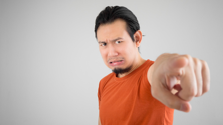 Crying Asian man pointing at camera.の写真素材