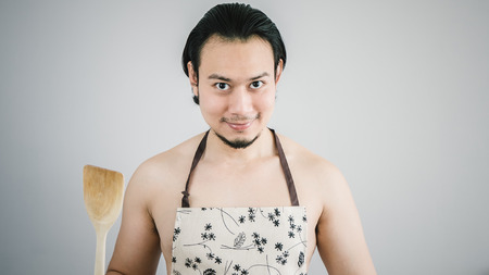 Asian husband ready to cook.の写真素材