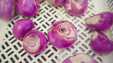 Minced shallots on wooden block.