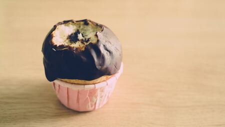 Bitten chocolate cupcakes in ball shape.の写真素材