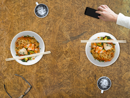 Bad manner of using smartphone while eating with other people.