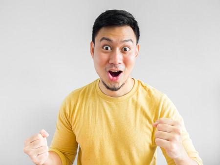 Happy Asian man face in yellow shirt.