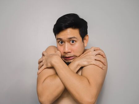 Topless Asian man feel freezing and panic.の写真素材