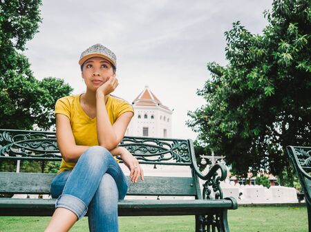 Tourist Asian woman sitting in the park in Bangkok.の写真素材