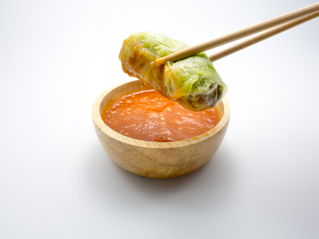 Stuffed cabbage rolls with spicy souce on white background.の写真素材