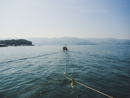 Adventure in the water of Thailand dam with boat pull the raft.