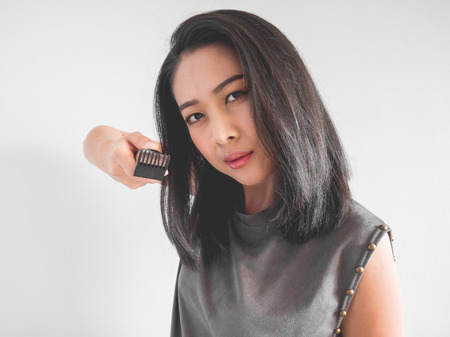 Asian woman wants to cut your hair with hair clipper.