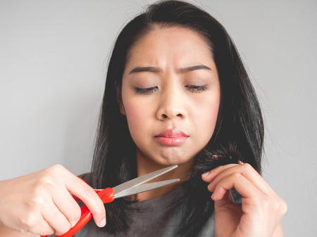 Asian woman wants to cut her damaged hair.の写真素材