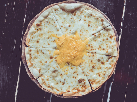 Cheese pizza thin and crisp serve on wooden table in classic style.の写真素材