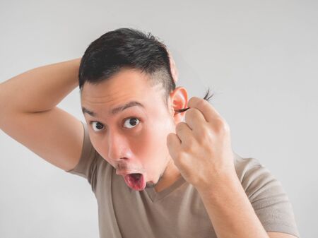Asian man cut his own hair with clipper and scissor.の写真素材