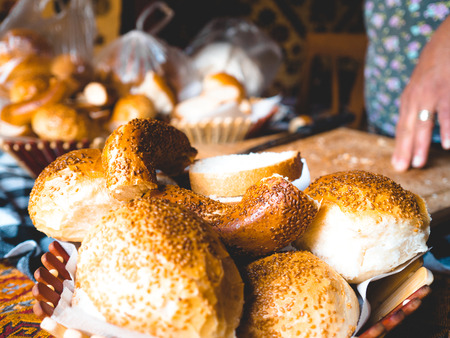 Turkish sesame bagel bread being cut and prepare for breakfast by housewife.の写真素材
