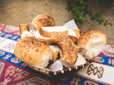 Turkish sesame bagel bread being cut and prepare for breakfast by housewife.の写真素材