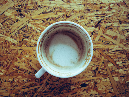 Top view of drank coffee cup on wooden table.