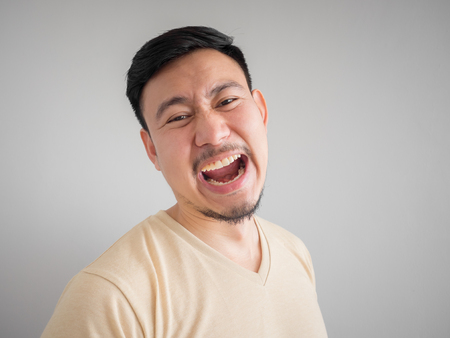 Headshot of crazy laughing face of Asian man with beard and mustache.の写真素材