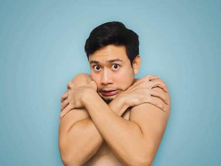 Topless Asian man feel freezing and panic.の写真素材