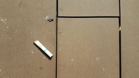 Unfinished cigarette dropped on the floor.の写真素材