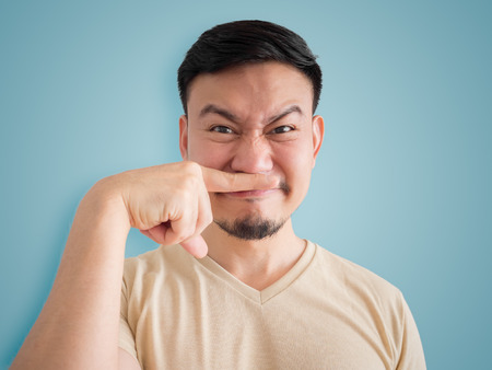 Headshot of smell something bad face of Asian man with beard and mustache.の写真素材