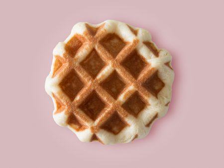 Honey brown waffle isolated on colour background.の写真素材