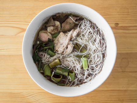 Thai Rice Vermicelli Pork Thicken Soup on wooden table.