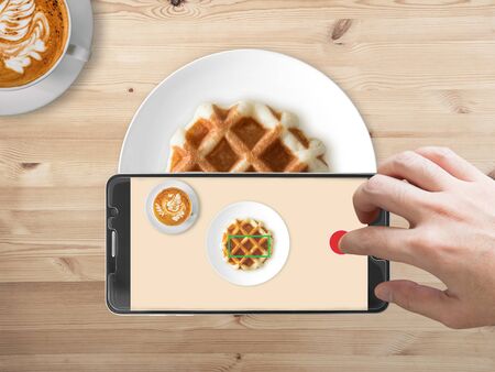 Taking food photography with smartphone on waffle.の写真素材