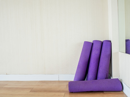 Rolls of yoga mats left in the yoga gym room.の写真素材