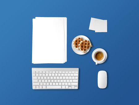 Flat lay office desk items in concept of working with coffee and pancakes.の写真素材